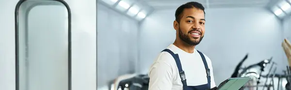 Skilled mechanic engages in his work, showcasing confidence and expertise in the workshop. — Stock Photo