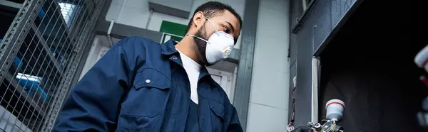 Skilled mechanic inspects machinery in a modern workshop, ensuring safety and precision. — Stock Photo
