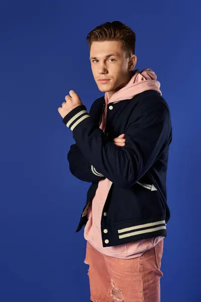 Young man stands confidently in a stylish outfit, radiating charm. — Stock Photo