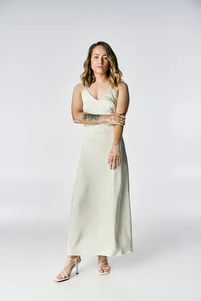 A young woman with vitiligo stands confidently in a simple studio, showcasing her beauty. — Stock Photo