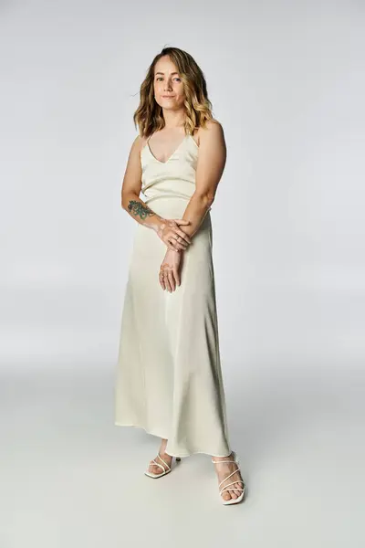 Young woman with vitiligo poses gracefully in a light dress, showcasing her beauty and confidence. — Stock Photo