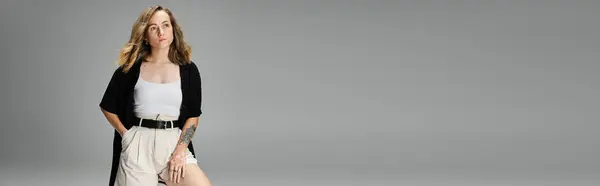 Young woman with vitiligo stands gracefully in a studio, showcasing her unique beauty and style. — Stock Photo