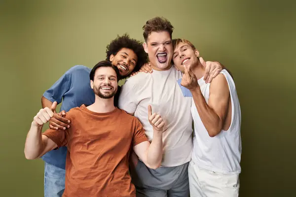 Four friends express joy and pride together, showcasing their vibrant personalities and unity. — Stock Photo