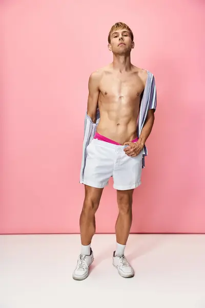 A person poses confidently in vibrant attire, showcasing queer fashion in a playful setting. — Stock Photo