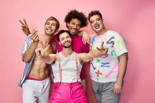 A joyful group of queer friends poses playfully against a bright pink backdrop. — Stock Photo