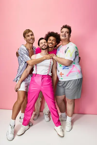 Group of friends joyfully embracing each other in colorful outfits during a pride celebration. — Stock Photo