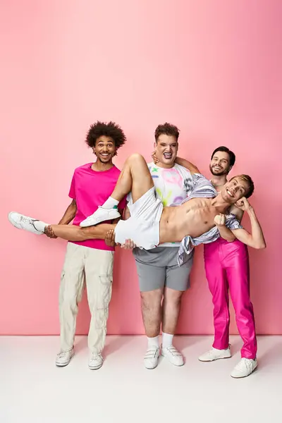 Four friends pose together, showcasing colorful outfits and a sense of celebration and unity. — Stock Photo