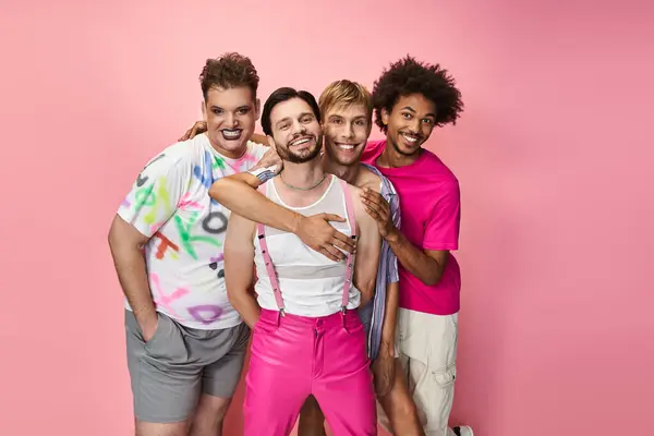 Four friends celebrate joy and pride in a colorful setting, highlighting their unique styles. — Stock Photo