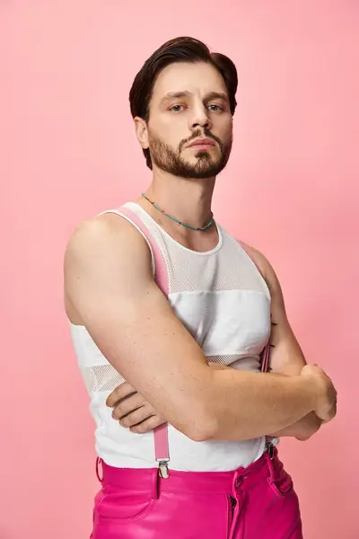 Person radiates confidence in bright attire against a pink backdrop, celebrating self expression. — Stock Photo