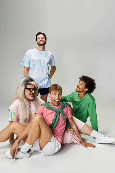 Four friends express joy and pride through colorful clothing and playful interactions together. — Stock Photo