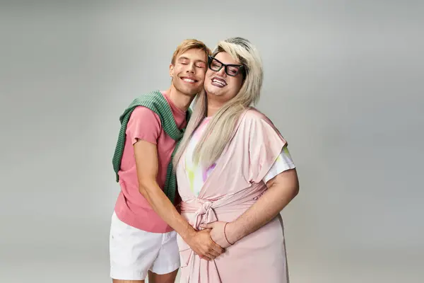Two friends embrace joyfully, showcasing vibrant attire and a celebration of LGBTQ pride. — Stock Photo