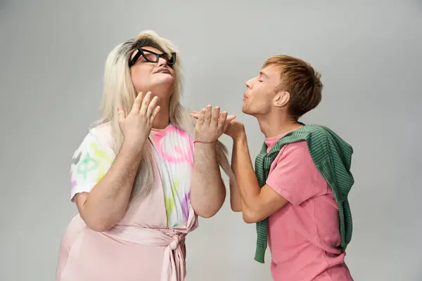 Two queer individuals showcase joy and creativity through playful interactions and bold fashion. — Stock Photo