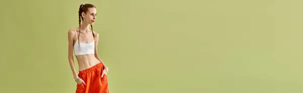 Young woman stands confidently against a plain backdrop, reflecting her journey with anorexia. — Stock Photo