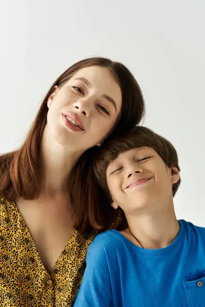 Young mother and her son share a cheerful moment, showcasing their strong bond and family love. — Stock Photo