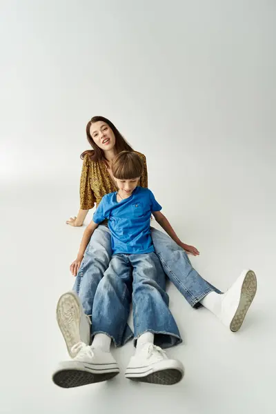 A young mother and her son enjoy a fun time together in a modern studio space filled with joy. — Stock Photo