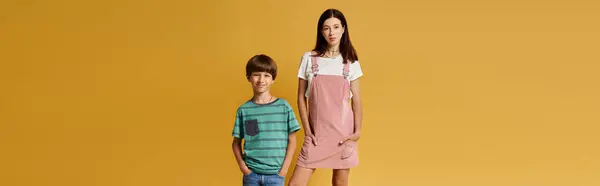 A young mother and her cheerful son pose together in a bright studio, capturing their bond. — Stock Photo
