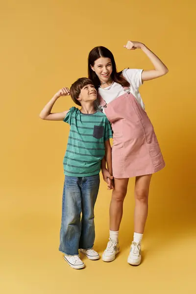 A young mother and her son happily pose together, showing their playful bond. — Stock Photo