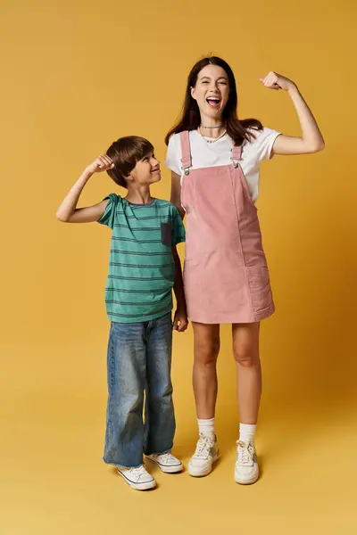 A young mother and her son share a playful moment in a studio, showcasing their bond. — Stock Photo