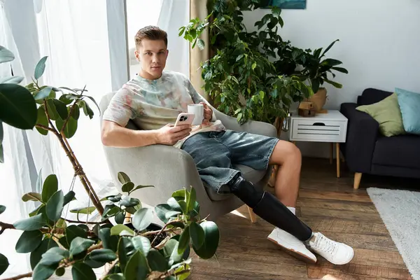 Handsome young man enjoys a quiet moment in a cozy living space, relaxed and at ease. — Stock Photo