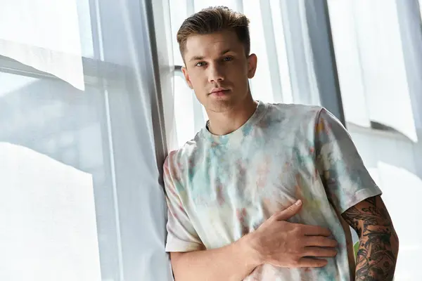 A young man showcases confidence and style in a bright, contemporary setting. — Stock Photo