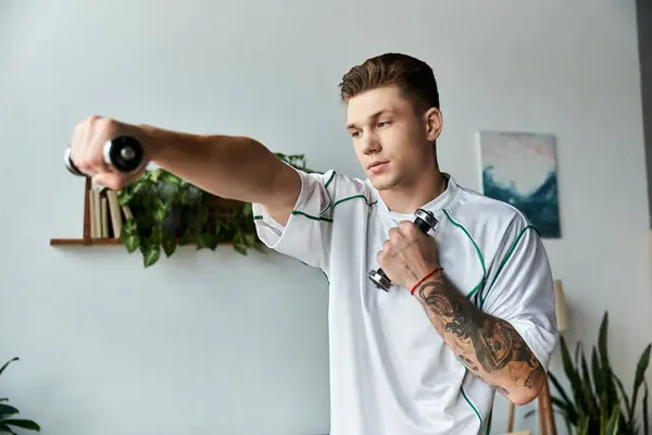 Handsome young man focuses on his workout, lifting weights with determination and strength. — Stock Photo
