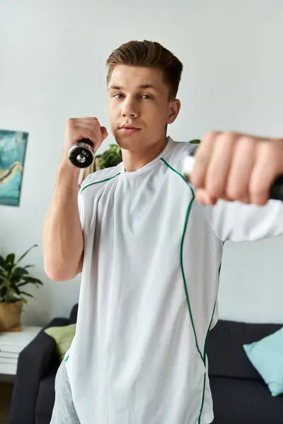 Young handsome man demonstrates determination and strength while exercising indoors. — Stock Photo