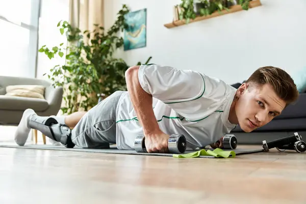Young man with prosthetic leg practices push ups, showcasing resilience and ambition indoors. — Stock Photo