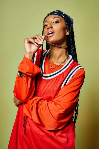 Young woman poses with attitude while adorned in vibrant clothing and stylish accessories. — Stock Photo