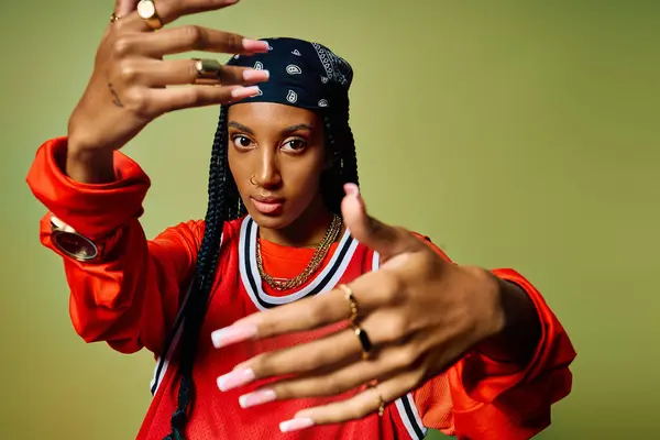 A young woman showcases her unique fashion sense and attitude with bold hand gestures. — Stock Photo