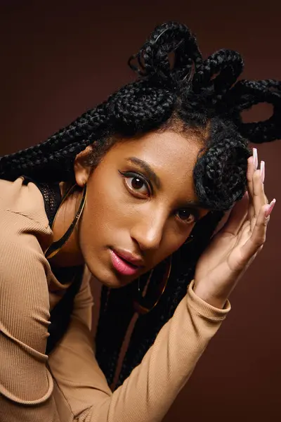 A young woman showcases her stunning braided hairstyle, exuding confidence and style. — Stock Photo