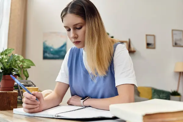 A pretty teenage girl engages in her studies at home, surrounded by personal touches and style. — Stock Photo