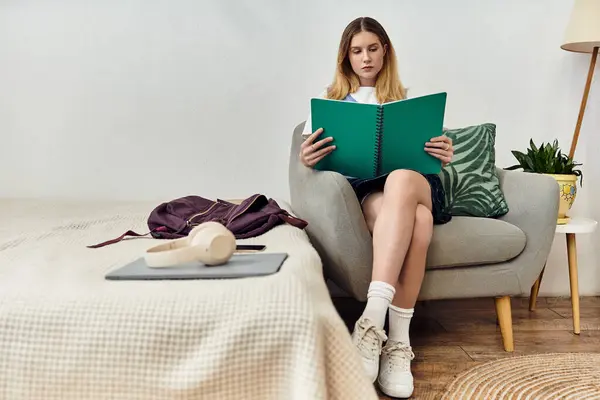 A creative teenager sits comfortably in her stylish room, enjoying a moment of inspiration. — Stock Photo