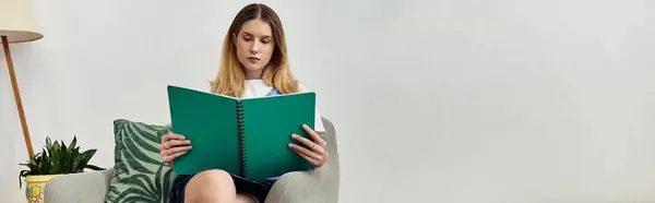 A teen girl writes in her journal, surrounded by personal touches in her stylish room, banner — Stock Photo