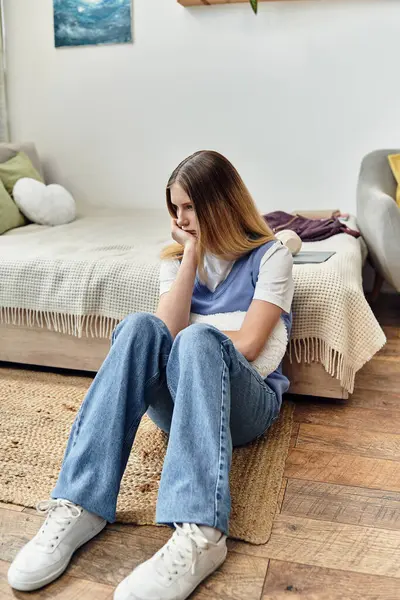 A sad teenage girl sitting in in her stylish and contemporary living space. — Stock Photo