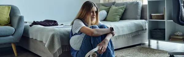 A sad teenage girl is engaged in her thoughts while sitting in her stylish room at home, banner — Stock Photo