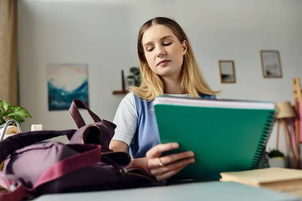 Pretty teenage girl sits in her room, engaging with her study materials in a cozy atmosphere. — Stock Photo