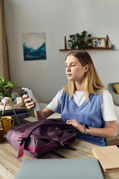 Teenage girl relaxes in her room, checking her phone while surrounded by personal items. — Stock Photo