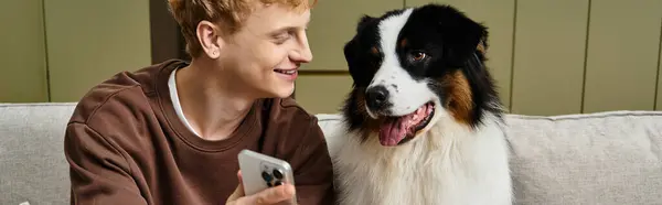 Joyful time spent in a modern apartment with a cute Australian Shepherd and a young man, banner — Stock Photo