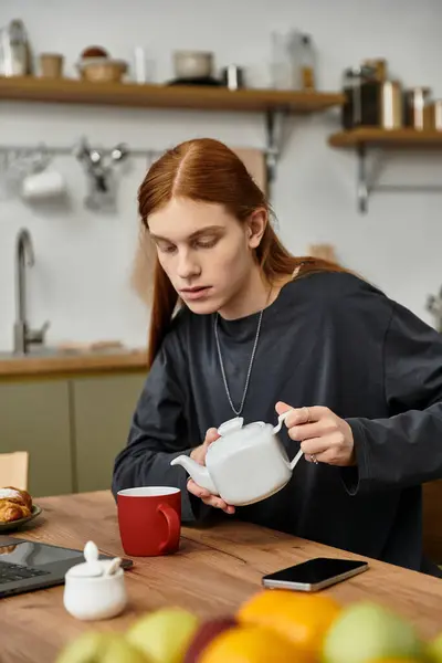 This stylish young man prepares tea in his cozy apartment, embracing a relaxed morning vibe. — Stock Photo