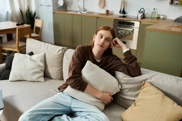 A fashionable young redhead relaxes in his stylish apartment, embracing a laid-back lifestyle. — Stock Photo