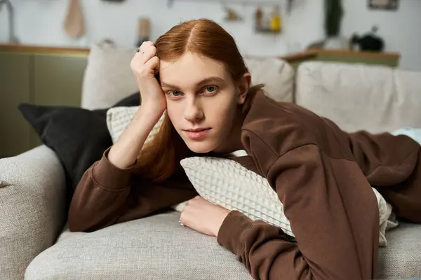 A handsome redhead with long hair relaxes in his stylish apartment, savoring the moment. — Stock Photo