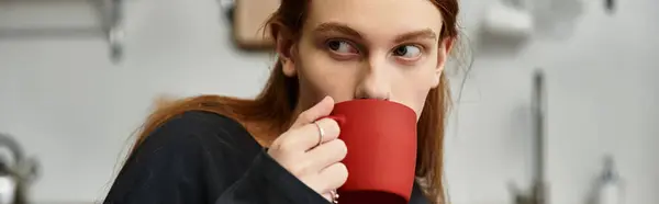 A stylish young man with long hair savors his coffee in a cozy modern apartment, banner — Stock Photo