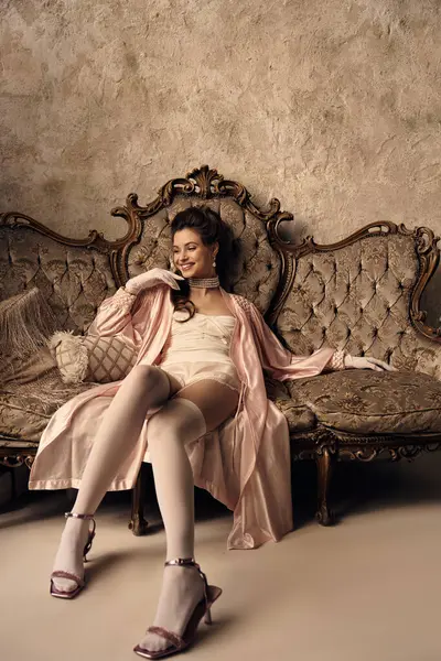 A beautiful young woman embodies fantasy while lounging gracefully in vintage attire, exuding charm. — Stock Photo