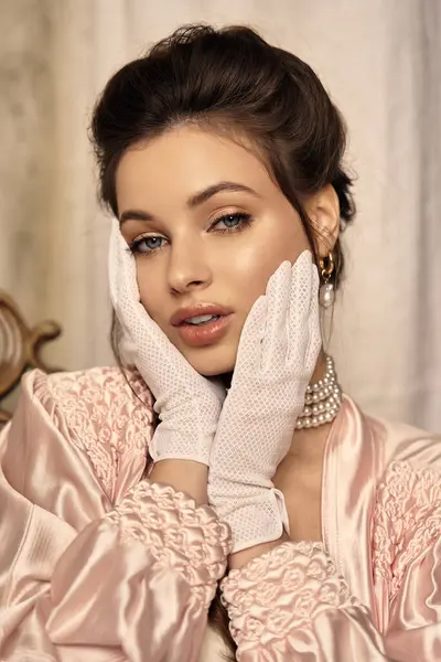 Young woman dressed in vintage style radiates allure, expressing a mystical charm in her pose. — Stock Photo