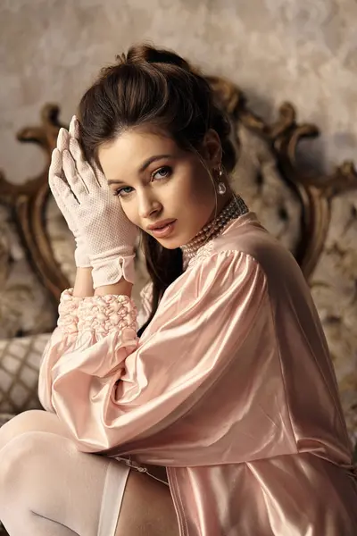 A lovely young woman sits gracefully in elegant vintage clothes, radiating a mystical aura. — Stock Photo