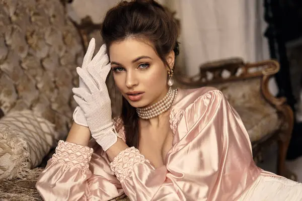 A beautiful young woman wears vintage clothing while displaying a mystical aura in a dreamy setting. — Stock Photo
