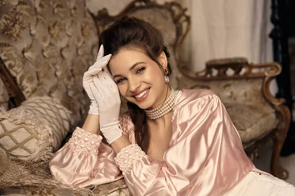 A young woman charmingly poses in elegant vintage attire, exuding a mystical aura and grace. — Stock Photo