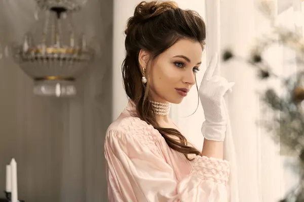 Beautiful young woman dressed in vintage clothing contemplates as she overlooks a dreamy landscape. — Stock Photo