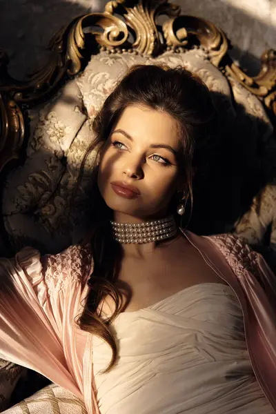 A beautiful nymph reclines gracefully, surrounded by vintage decor, illuminated by soft light. — Stock Photo