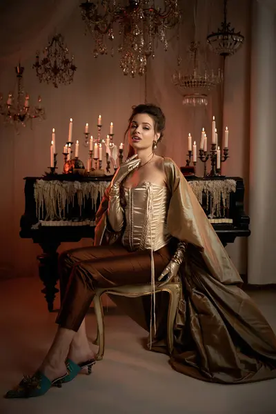 A young woman embodies a mystical vampire in an elegant ballroom, surrounded by flickering candles. — Stock Photo